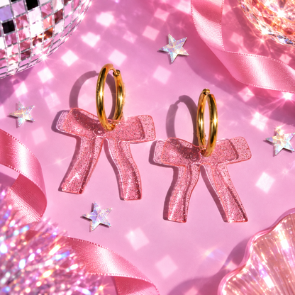 Sparkly pink bow hoop earrings with translucent glitter acrylic bow charms by Cuteryko