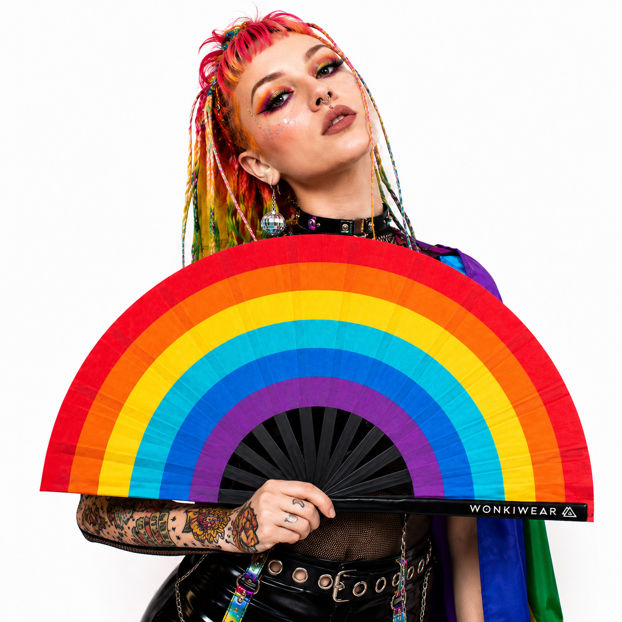 Model holding Spectrum Rainbow XL Pride festival fan in colourful festival outfit