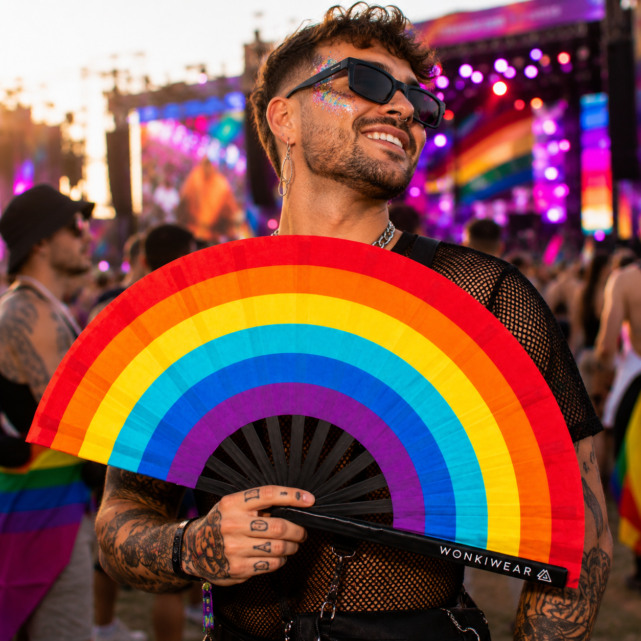 Male festival model holding Spectrum Rainbow XL Pride hand fan