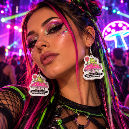 Woman wearing frog and mushroom “Negative Self-Talk Not Allowed” statement earrings at a colourful neon rave