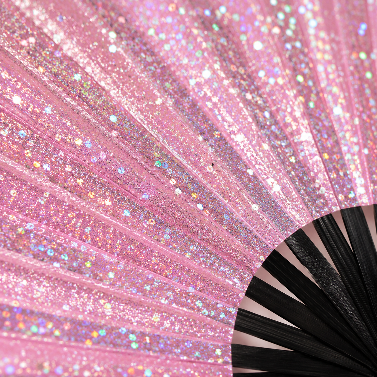 Close-up of pink glitter festival fan showing sparkling glitter finish