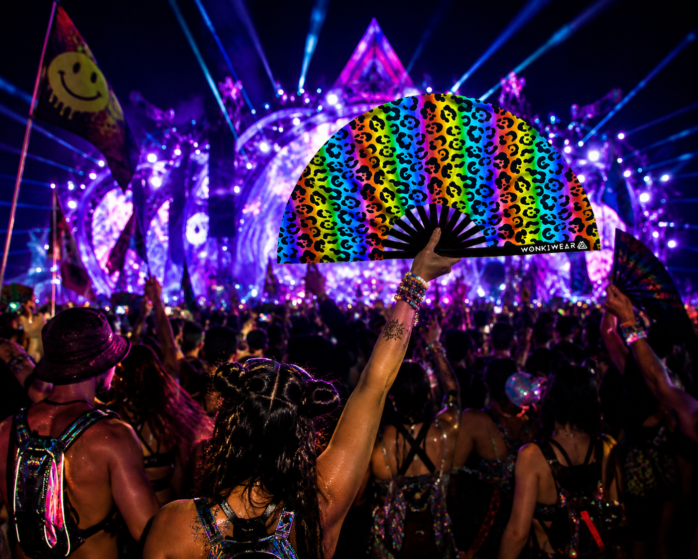 UV reactive rainbow leopard print festival fan glowing in rave crowd