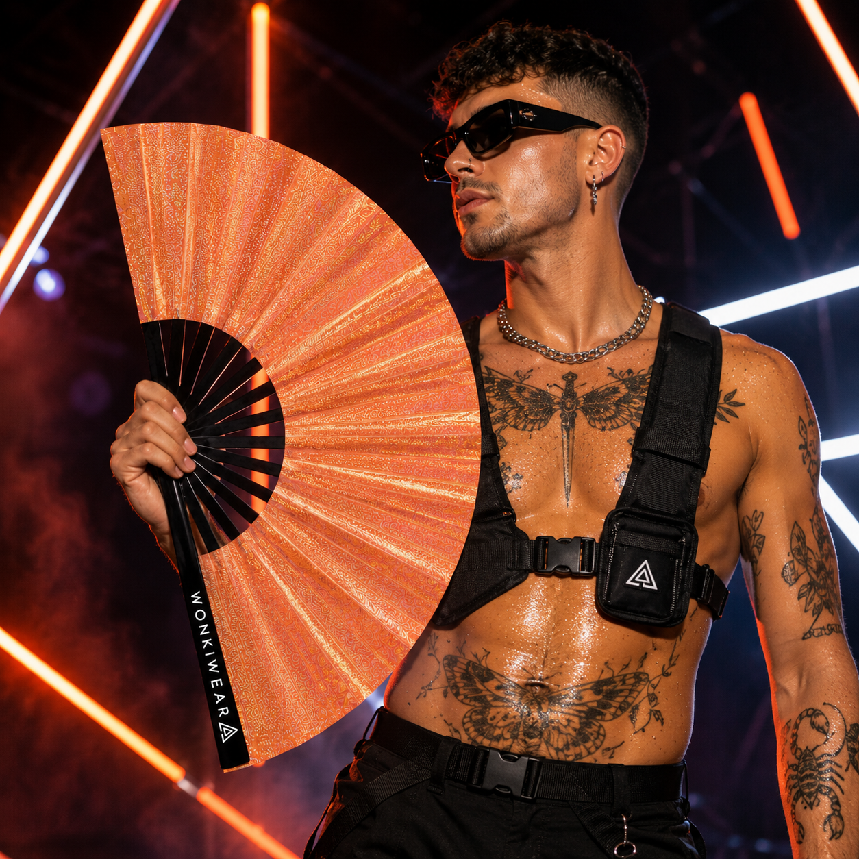 Male rave attendee holding Venus Galaxy holographic metallic orange XL festival fan