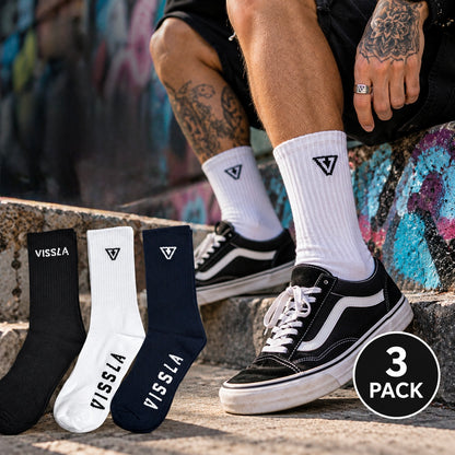 Vissla Logo Socks worn with skate shoes in an urban streetwear setting, with black, white and navy socks shown