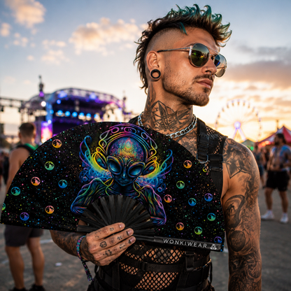 Male festival-goer holding the Voidwalker psychedelic alien XL folding fan