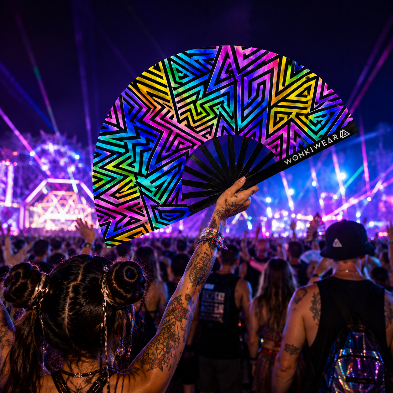 Crowd lifestyle image of UV reactive abstract festival fan at a rave