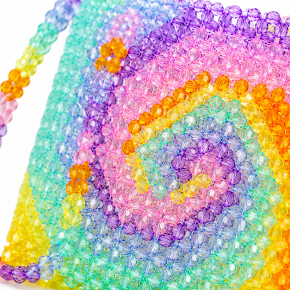 Macro close up of colourful faceted beads on handmade spiral shoulder bag