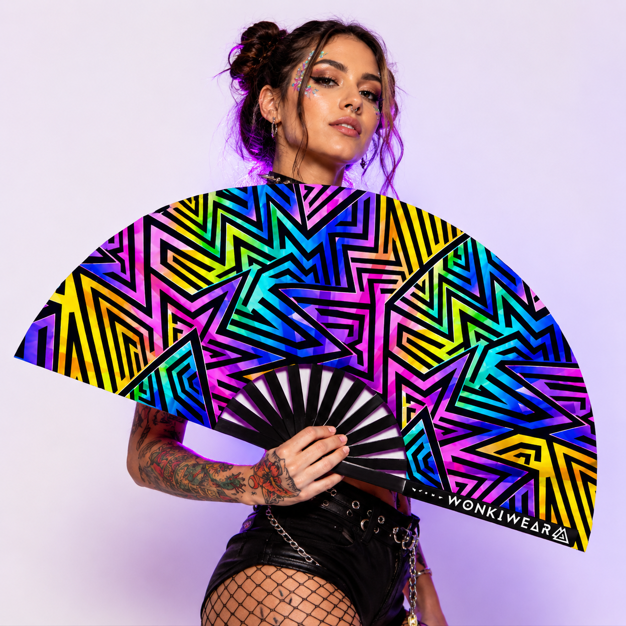 Female rave model holding XL UV reactive abstract festival fan