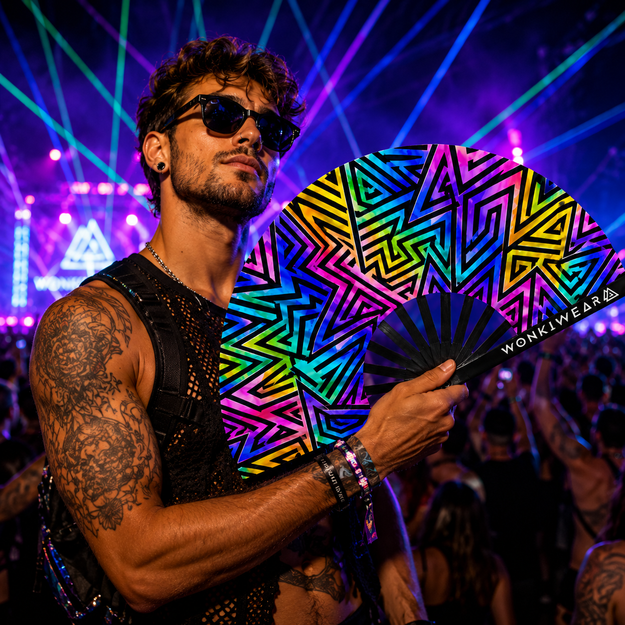 Male festival model holding UV reactive abstract rave fan
