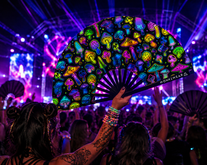 Crowd lifestyle image of XL UV reactive mushroom festival fan at a rave