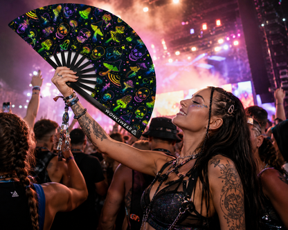 Female festival model holding XL UV reactive mushroom and skulls rave fan at rave