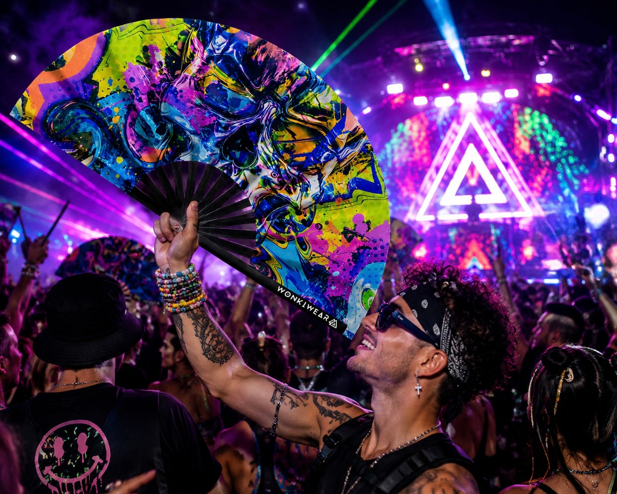 Festival crowd using neon graffiti skull UV reactive rave fan under event lighting