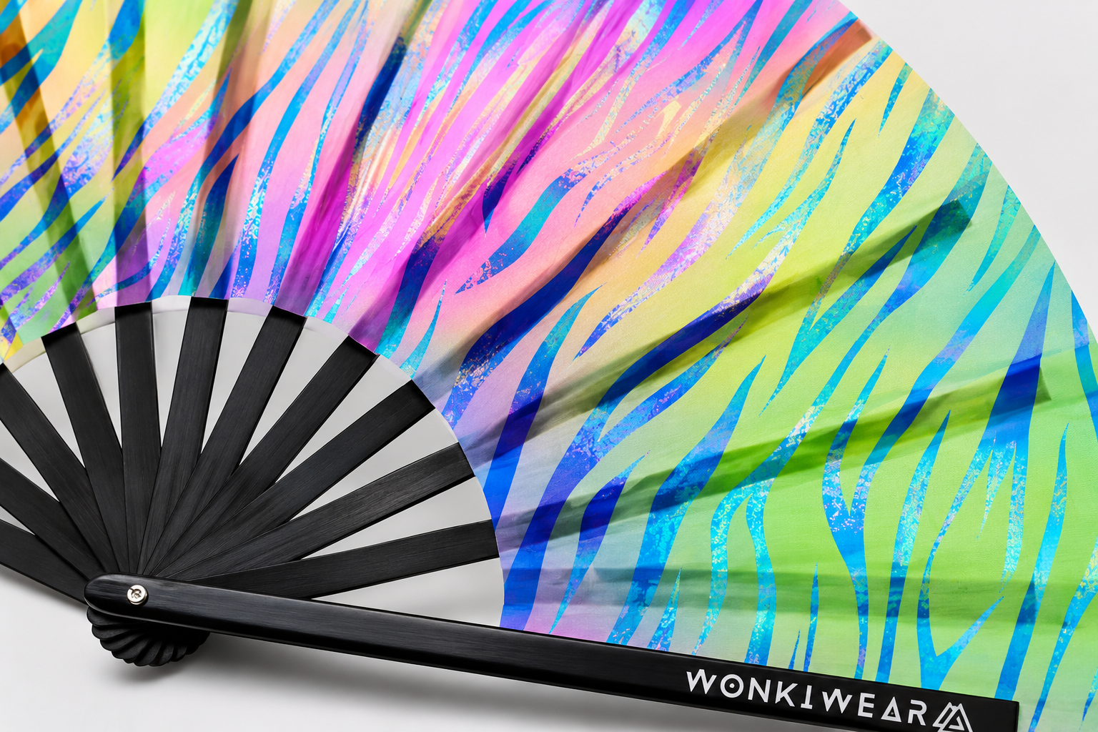Close up detail of pastel zebra UV reactive rave fan fabric and black bamboo ribs