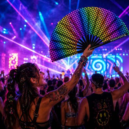Festival crowd using XL UV reactive chequered rave fan at a nightclub or music festival