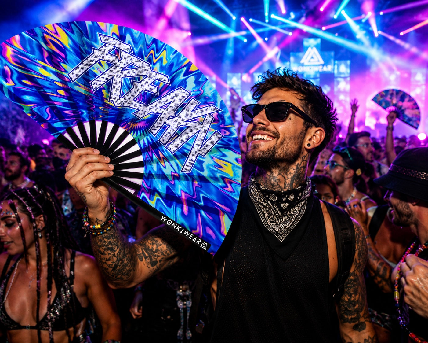 Male festival model holding XL UV reactive FREAKY rave fan