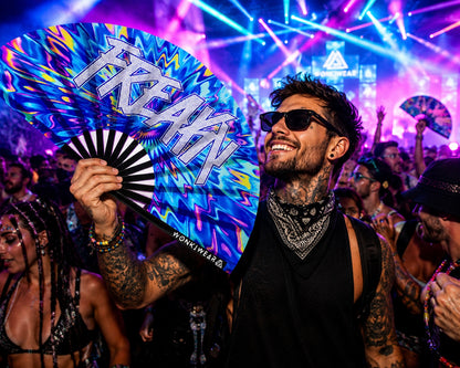 Male festival model holding XL UV reactive FREAKY rave fan