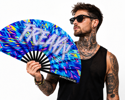 Male festival model holding XL UV reactive FREAKY rave fan