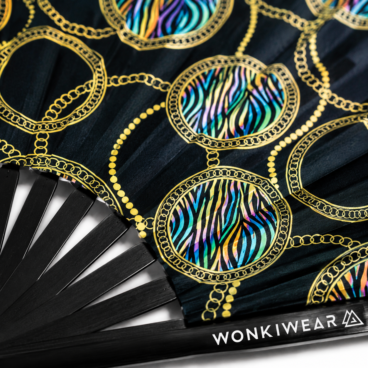 Close up detail of UV reactive chain and zebra print rave fan with black bamboo ribs