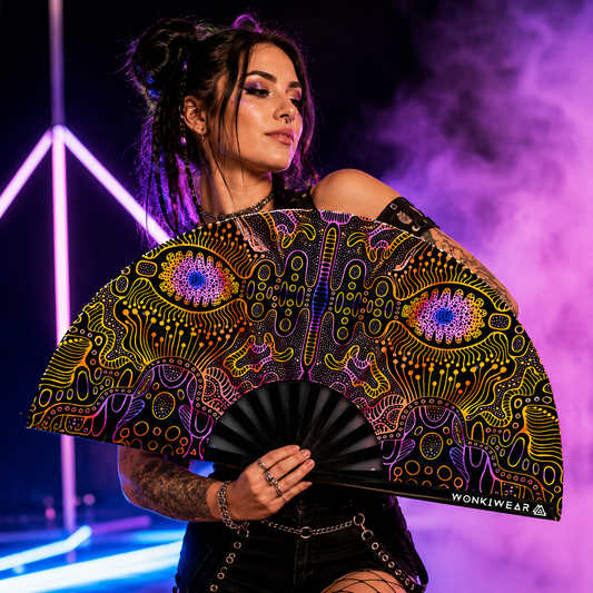 Female festival model holding XL UV reactive techno psytrance rave fan